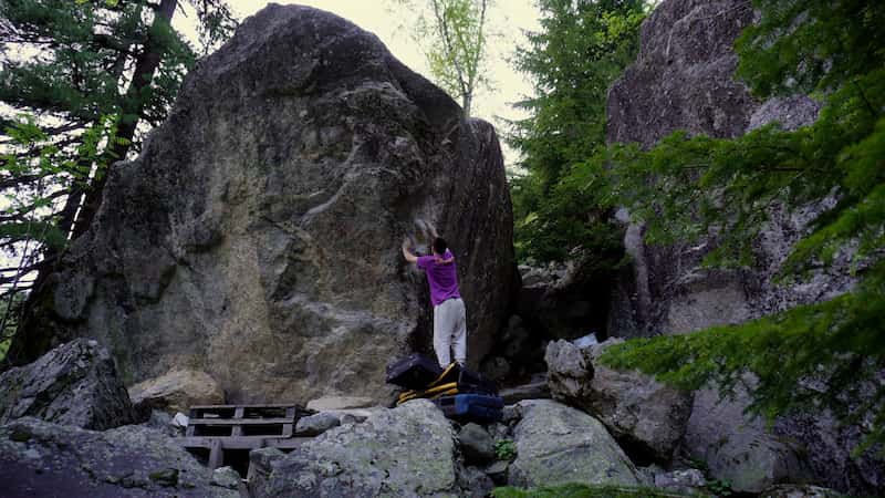 Stacking 3 crashpads to brush the holds on Kurban